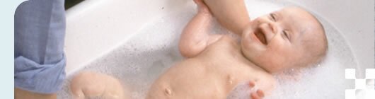 photo of a baby being bathed